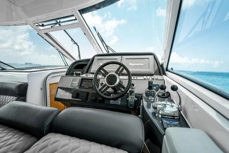 Pura Vida Yacht Photos Pics Interior view of 2011 Four Winns 475 yacht cockpit with ocean backdrop.