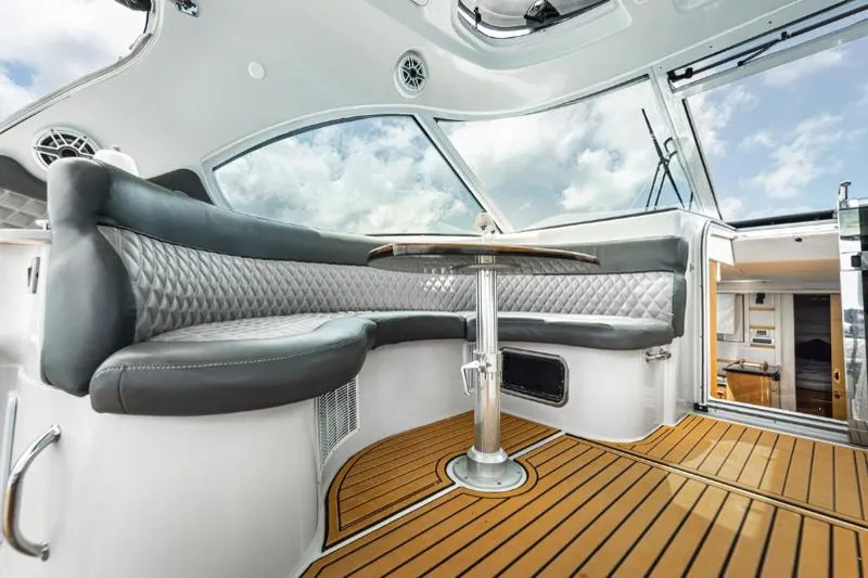 Pura Vida Yacht Photos Pics Luxurious interior of 2011 Four Winns 475 yacht with elegant seating and wooden flooring.