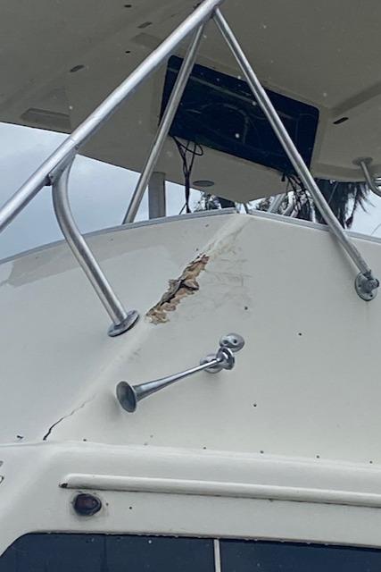 Damaged 1984 Post 43 Sport Fisherman boat with visible hull crack and exposed interior.