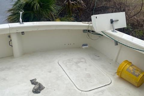 1984 Post 43 Sport Fisherman boat deck with yellow bucket and greenery.