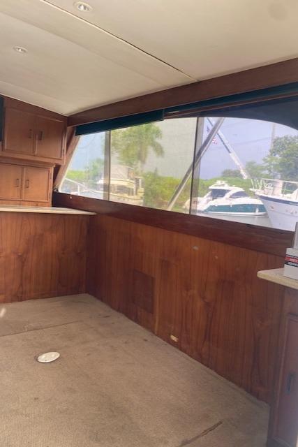 Interior of 1984 Post 43 Sport Fisherman boat with wood paneling and large windows.
