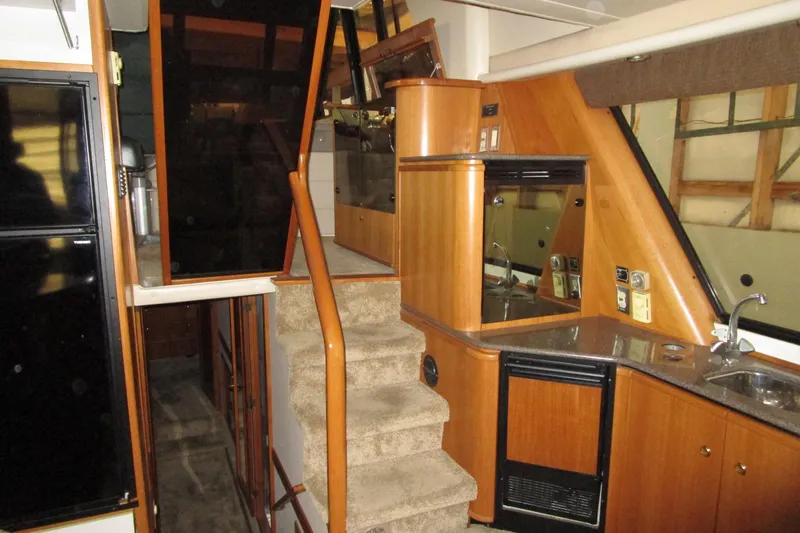 Yeah Yacht Photos Pics 1999 Bayliner 4788 Pilot House Motoryacht interior with stairs and kitchenette.