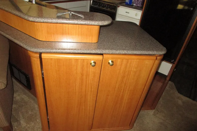 Yeah Yacht Photos Pics 1999 Bayliner 4788 Pilot House Motoryacht interior with wooden cabinetry and countertop.