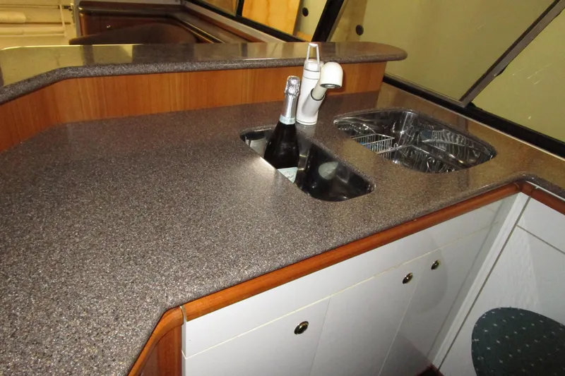Yeah Yacht Photos Pics 1999 Bayliner 4788 Pilot House Motoryacht kitchen with sink, faucet, and countertop.