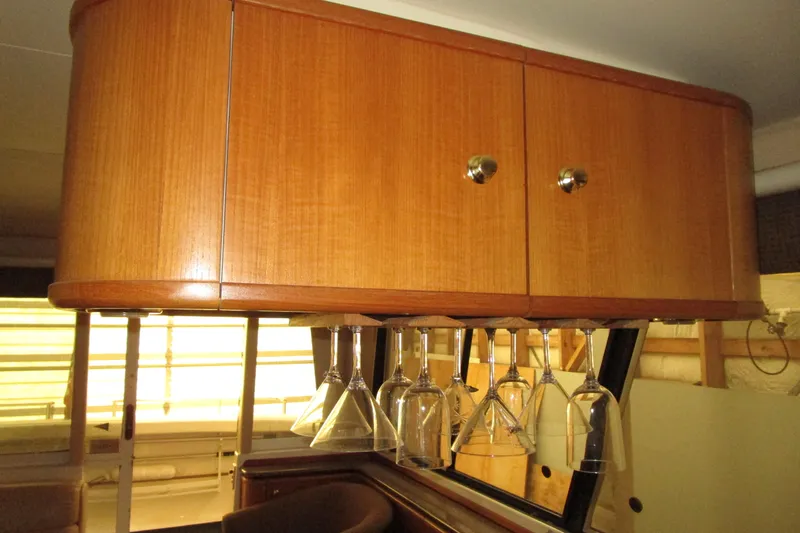 Yeah Yacht Photos Pics Wooden cabinet with hanging glassware in a 1999 Bayliner 4788 Pilot House Motoryacht.