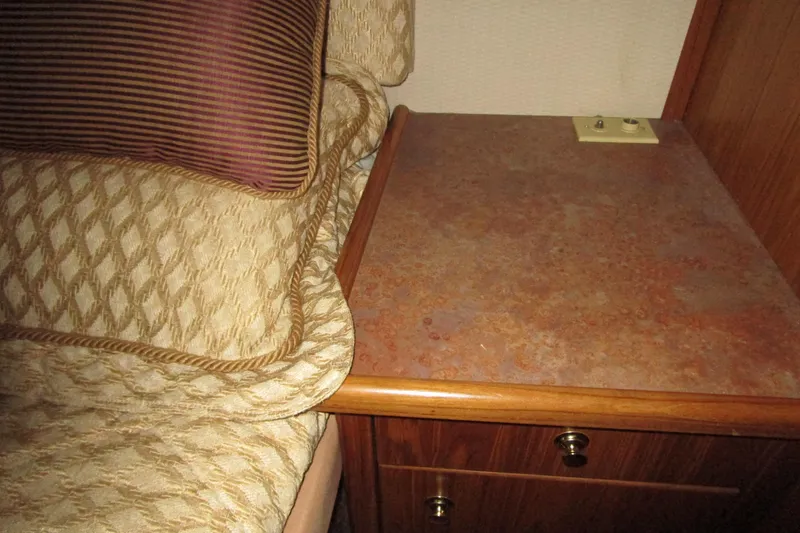 Yeah Yacht Photos Pics 1999 Bayliner 4788 Pilot House Motoryacht interior with bed and wooden nightstand.