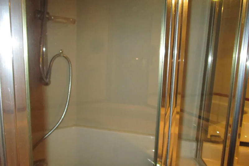 Yeah Yacht Photos Pics Shower area in 1999 Bayliner 4788 Pilot House Motoryacht with glass doors and chrome fixtures.