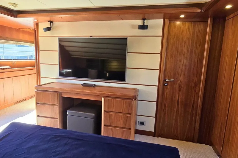 M/y Bleu Blanc Yacht Photos Pics Luxurious interior of 2009 Ferretti Custom Line 97 yacht with wood paneling and flat-screen TV.