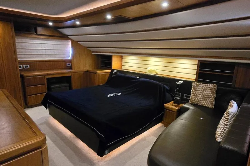 M/y Bleu Blanc Yacht Photos Pics Luxurious bedroom interior of 2009 Ferretti Custom Line 97 yacht with modern wood finishes.