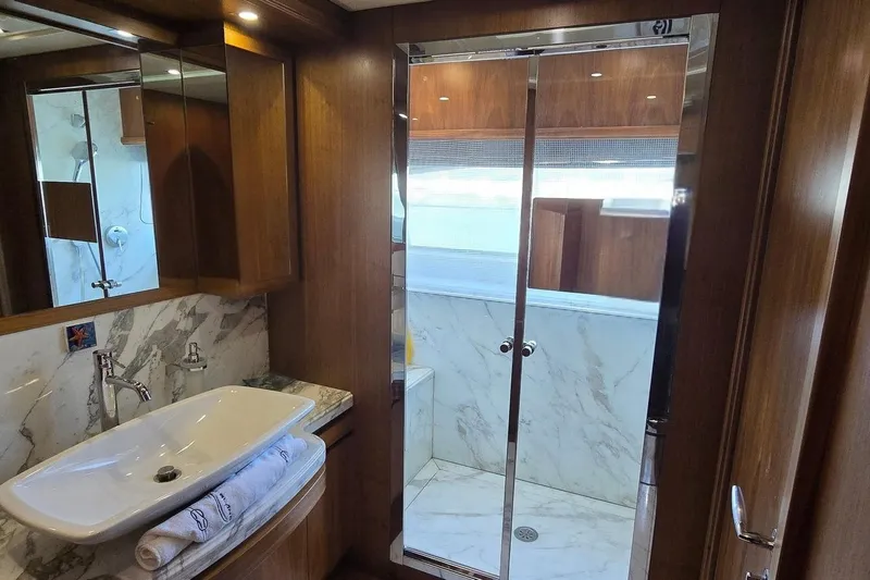 M/y Bleu Blanc Yacht Photos Pics Luxurious bathroom in 2009 Ferretti Custom Line 97 yacht with marble and wood finishes.