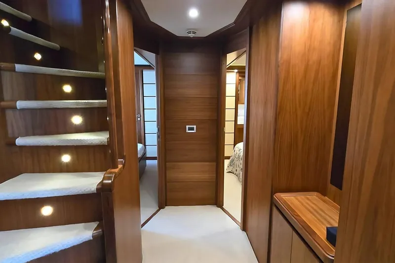 M/y Bleu Blanc Yacht Photos Pics Luxurious wooden interior of 2009 Ferretti Custom Line 97 yacht, featuring elegant staircase and hallway.