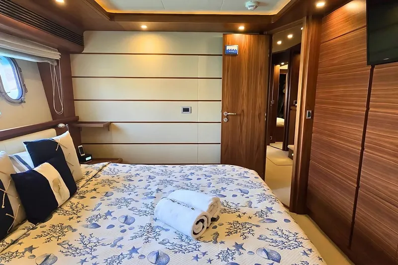 M/y Bleu Blanc Yacht Photos Pics Luxurious bedroom interior on 2009 Ferretti Custom Line 97 yacht, featuring elegant wood paneling.