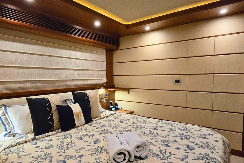 M/y Bleu Blanc Yacht Photos Pics Luxurious bedroom interior on 2009 Ferretti Custom Line 97 yacht, featuring elegant bedding and ambient lighting.