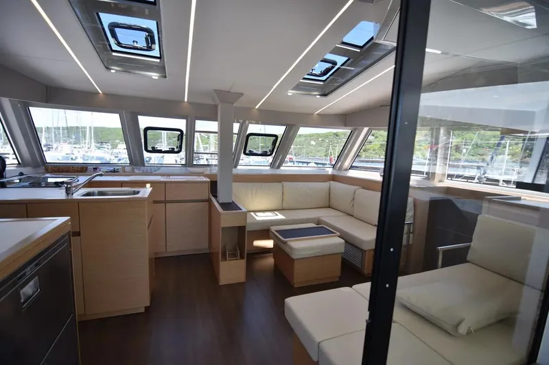 Stefany Yacht Photos Pics Luxurious interior of 2019 Nautitech 46 Fly catamaran with modern seating and panoramic windows.