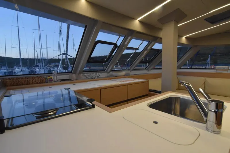 Stefany Yacht Photos Pics Interior of 2019 Nautitech 46 Fly catamaran with modern kitchen and marina view.