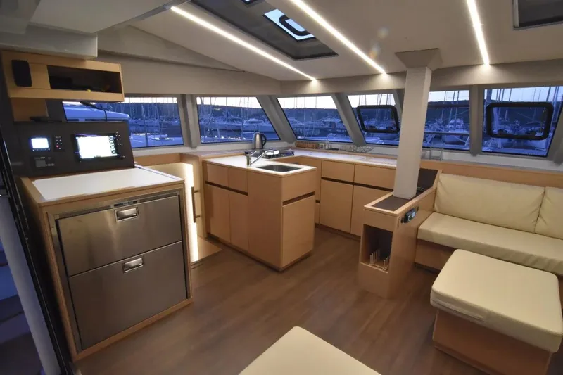 Stefany Yacht Photos Pics Luxurious interior of 2019 Nautitech 46 Fly catamaran with modern kitchen and seating area.