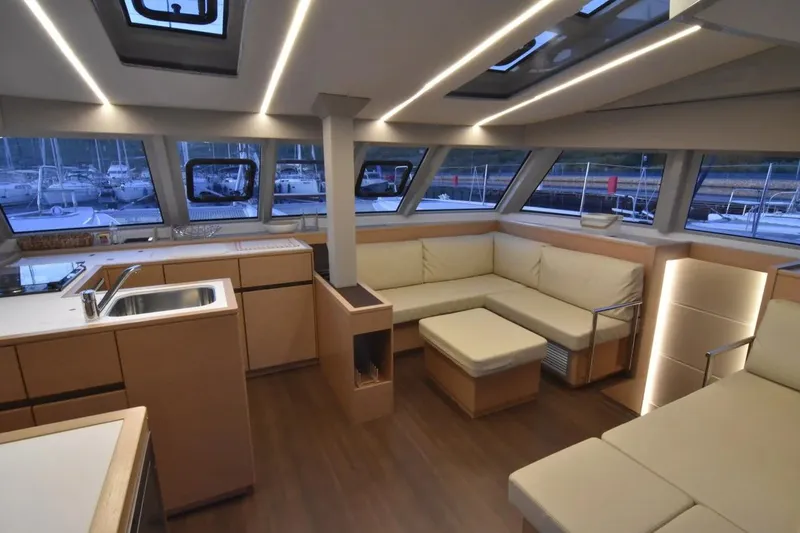 Stefany Yacht Photos Pics Luxurious interior of 2019 Nautitech 46 Fly catamaran with modern kitchen and seating area.