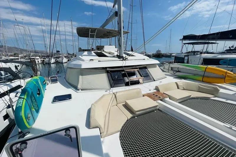 Stefany Yacht Photos Pics 2019 Nautitech 46 Fly catamaran docked, featuring spacious deck and seating area.