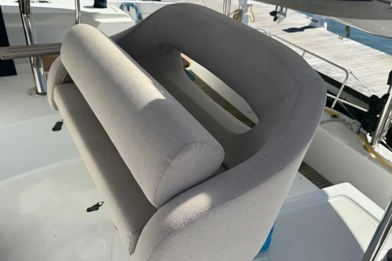 About Time Yacht Photos Pics Helm seat on 2021 Lagoon 42 catamaran, featuring comfortable gray upholstery.