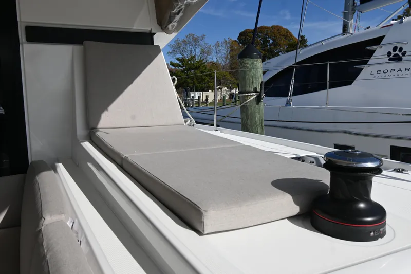 About Time Yacht Photos Pics Luxury Lagoon 42 catamaran deck with sunbed, 2021 model, docked at marina.