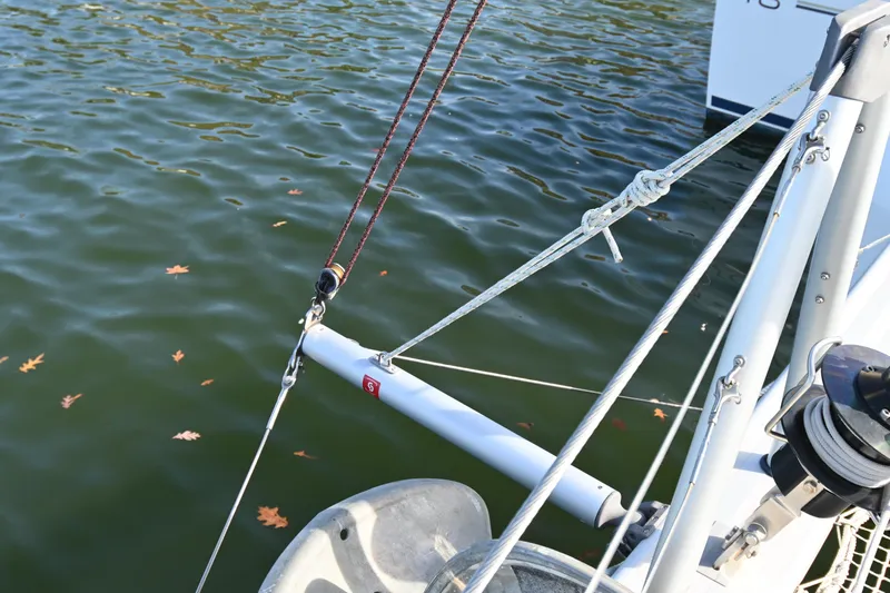 About Time Yacht Photos Pics Sailboat rigging on 2021 Lagoon 42 catamaran, with water and autumn leaves.
