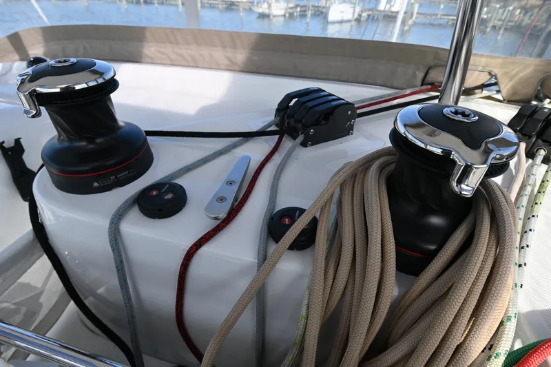About Time Yacht Photos Pics Winches and ropes on a 2021 Lagoon 42 catamaran deck, marina in background.
