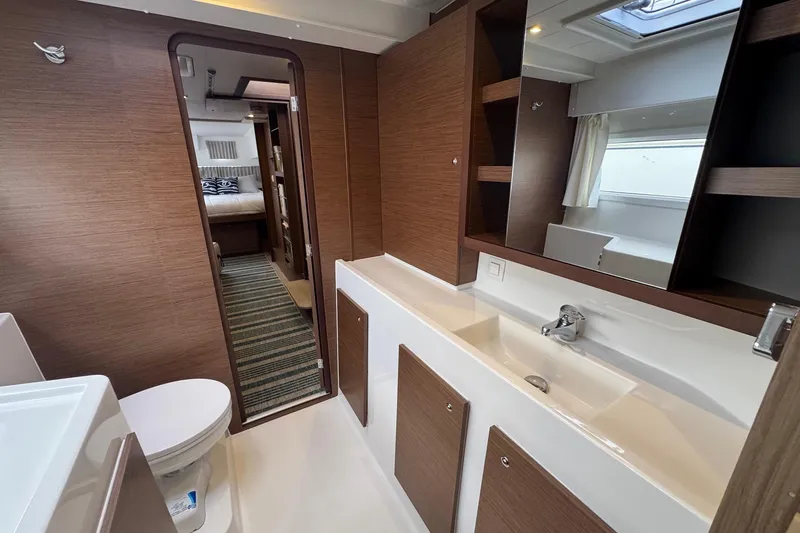 About Time Yacht Photos Pics Luxurious interior of 2021 Lagoon 42 yacht featuring modern bathroom and cozy bedroom.