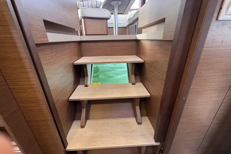 About Time Yacht Photos Pics Interior wooden stairs on a 2021 Lagoon 42 catamaran yacht.