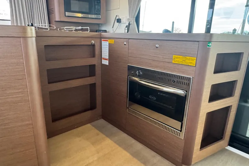 About Time Yacht Photos Pics Modern kitchen area in a 2021 Lagoon 42 catamaran with microwave and oven.