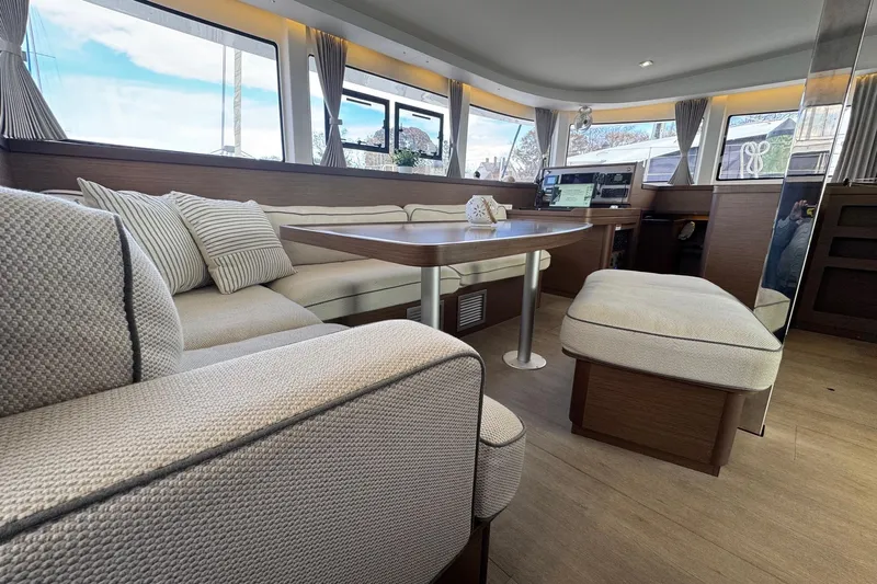 About Time Yacht Photos Pics Luxurious interior of 2021 Lagoon 42 catamaran with elegant seating and modern design.