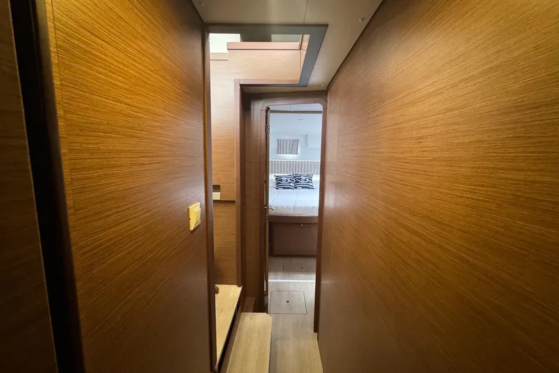 About Time Yacht Photos Pics Interior hallway of 2021 Lagoon 42 catamaran, leading to a cozy bedroom.