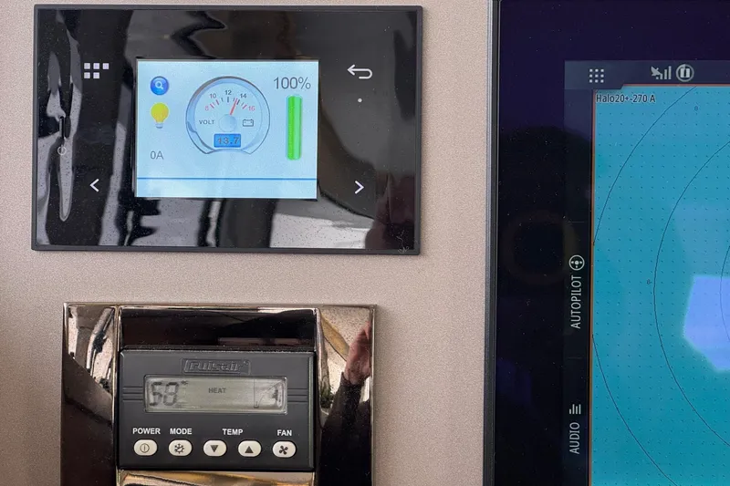 About Time Yacht Photos Pics Control panel of a 2021 Lagoon 42 catamaran with digital displays.