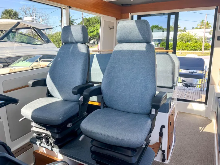 Ocean Therapy Yacht Photos Pics Interior of 2021 Nimbus C-11 boat with two comfortable captain chairs.