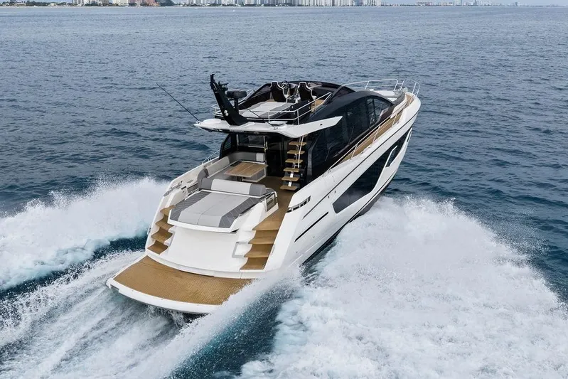  Yacht Photos Pics 2022 Sunseeker 65 Sport Yacht cruising on open water, showcasing sleek design and luxury.