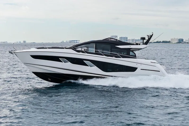  Yacht Photos Pics 2022 Sunseeker 65 Sport Yacht cruising on open water, showcasing sleek design and luxury.