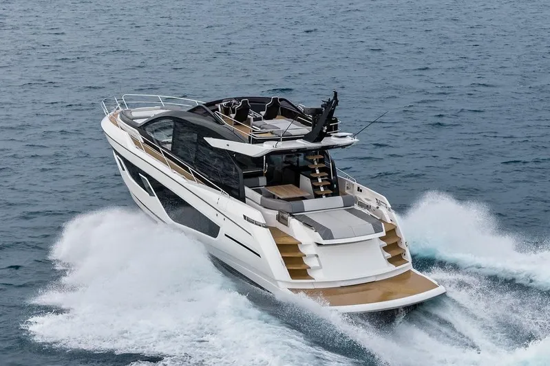  Yacht Photos Pics 2022 Sunseeker 65 Sport Yacht cruising on open water, showcasing sleek design and luxury.