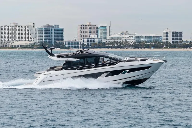  Yacht Photos Pics 2022 Sunseeker 65 Sport Yacht cruising near city skyline.