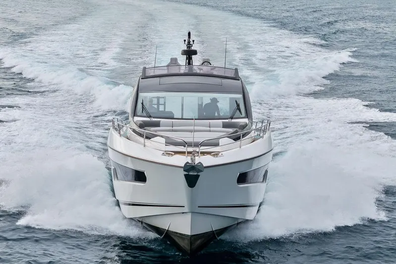  Yacht Photos Pics 2022 Sunseeker 65 Sport Yacht cruising on open water, front view.