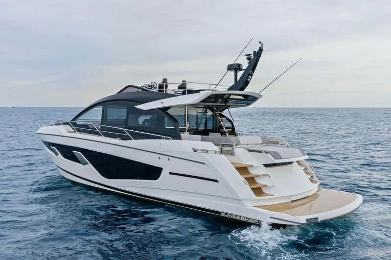  Yacht Photos Pics 2022 Sunseeker 65 Sport Yacht cruising on open sea, showcasing sleek design and luxury features.