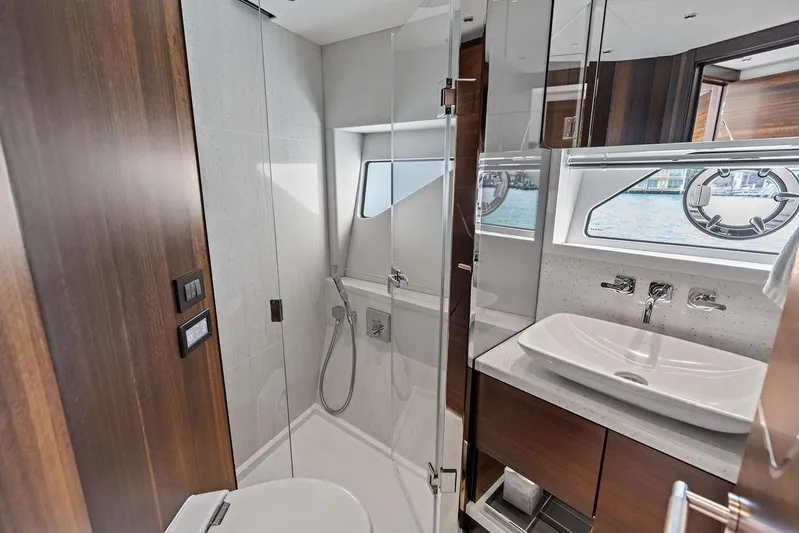 Yacht Photos Pics Luxurious bathroom in 2022 Sunseeker 65 Sport Yacht with modern fixtures and elegant design.