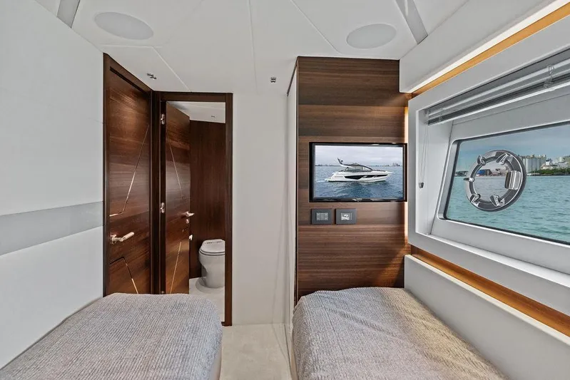  Yacht Photos Pics Interior of 2022 Sunseeker 65 Sport Yacht cabin with twin beds and ocean view.
