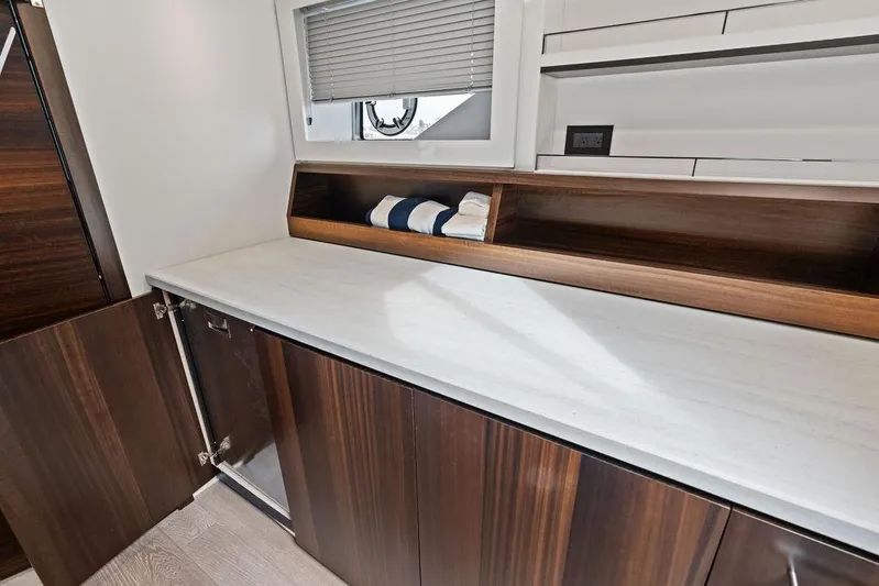 Yacht Photos Pics Interior of 2022 Sunseeker 65 Sport Yacht with sleek wooden cabinetry and modern design.