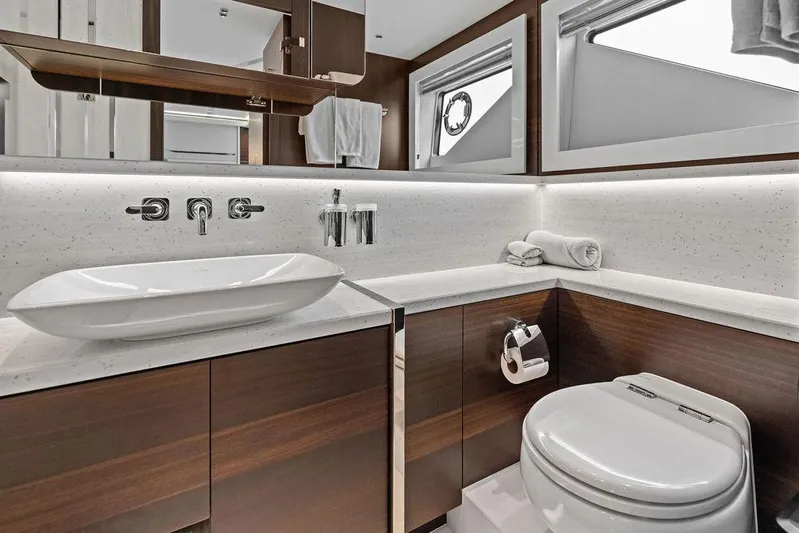  Yacht Photos Pics Luxurious bathroom in 2022 Sunseeker 65 Sport Yacht with modern fixtures and elegant design.