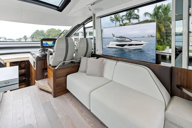  Yacht Photos Pics Luxurious interior of 2022 Sunseeker 65 Sport Yacht with modern seating and navigation area.