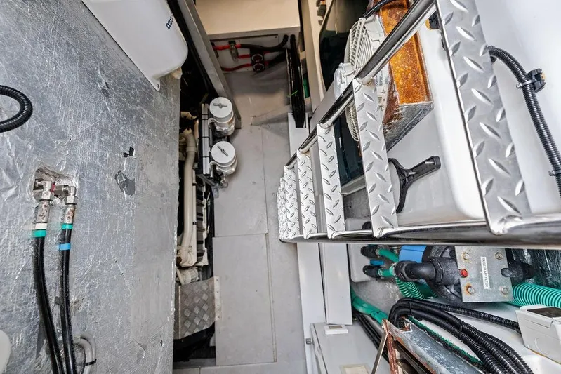  Yacht Photos Pics Engine room of 2022 Sunseeker 65 Sport Yacht with visible machinery and ladder.