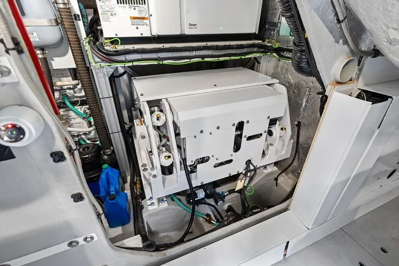  Yacht Photos Pics Engine room of 2022 Sunseeker 65 Sport Yacht, showcasing mechanical components and wiring.