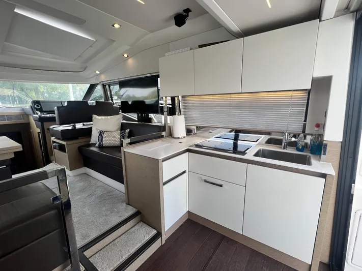  Yacht Photos Pics Luxurious interior of a 2018 Prestige 460 yacht featuring a modern kitchen and seating area.