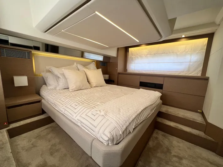  Yacht Photos Pics Luxurious bedroom interior of 2018 Prestige 460 yacht with elegant bedding and ambient lighting.