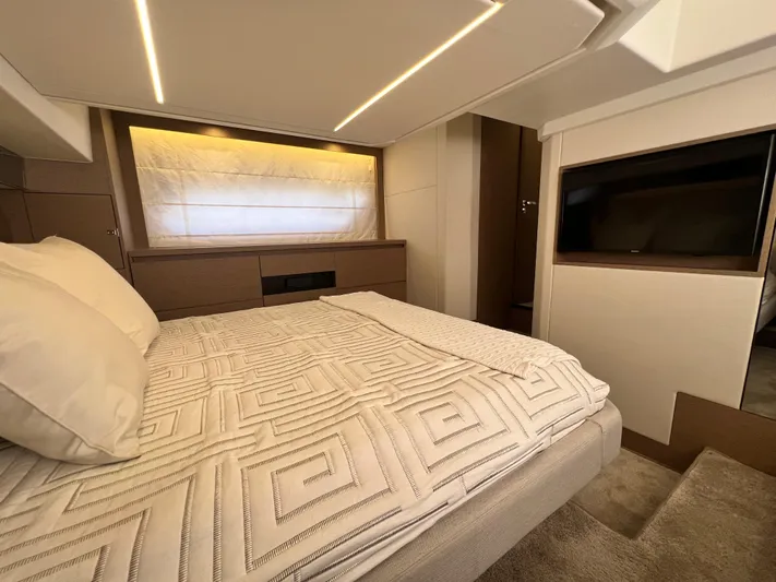  Yacht Photos Pics Luxurious bedroom interior of 2018 Prestige 460 yacht with modern design and ambient lighting.
