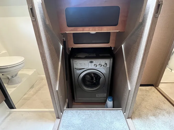  Yacht Photos Pics Laundry area with washing machine in 2018 Prestige 460 yacht interior.